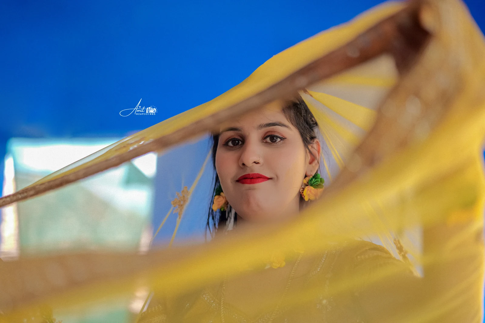 A portrait framed by a yellow drape