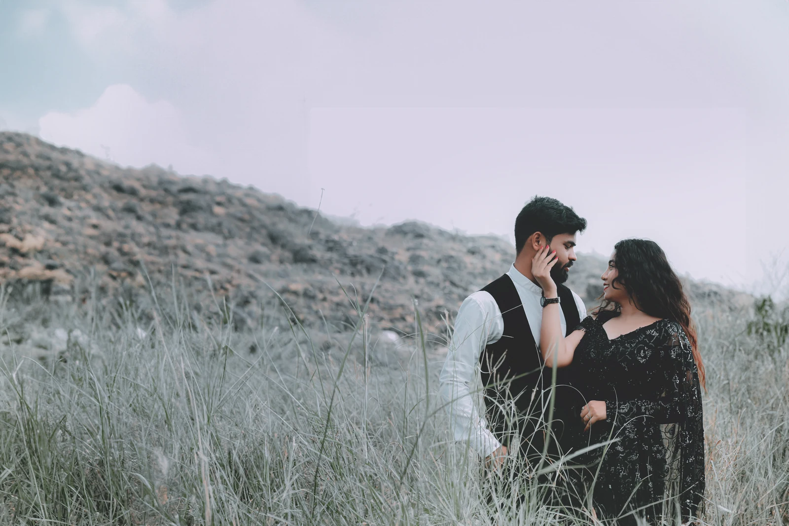 A couple together in an open landscape