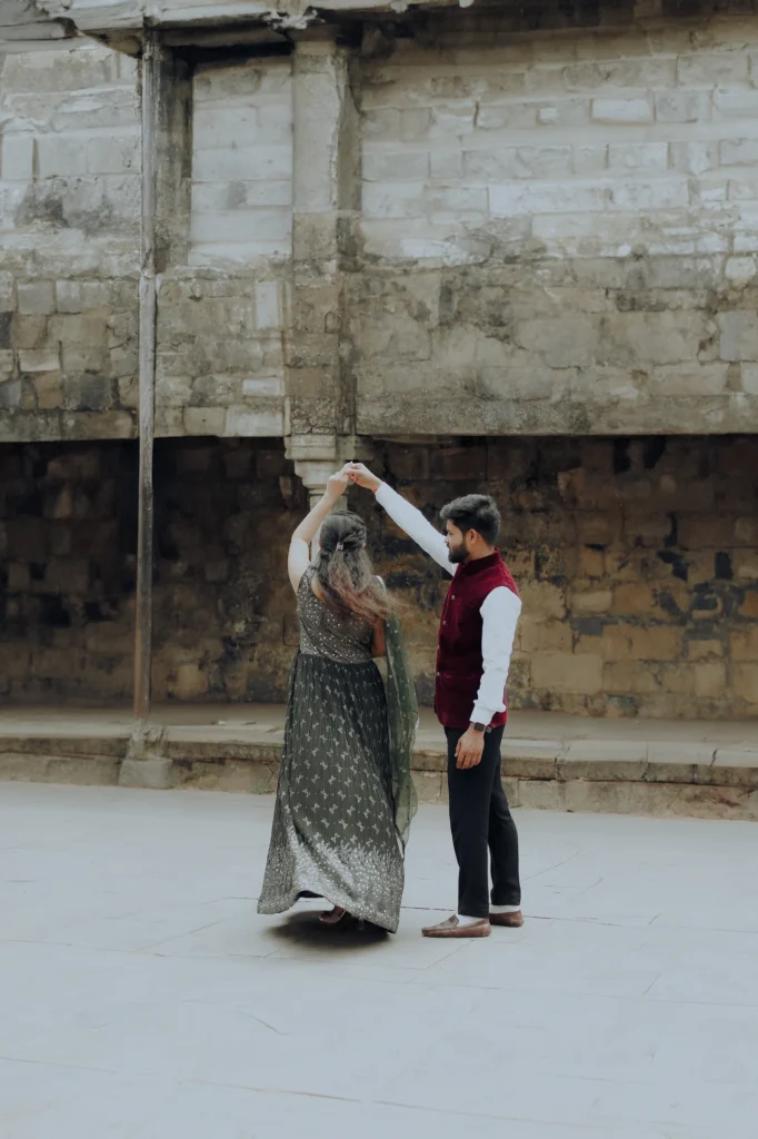 A couple framed by historic stone architecture